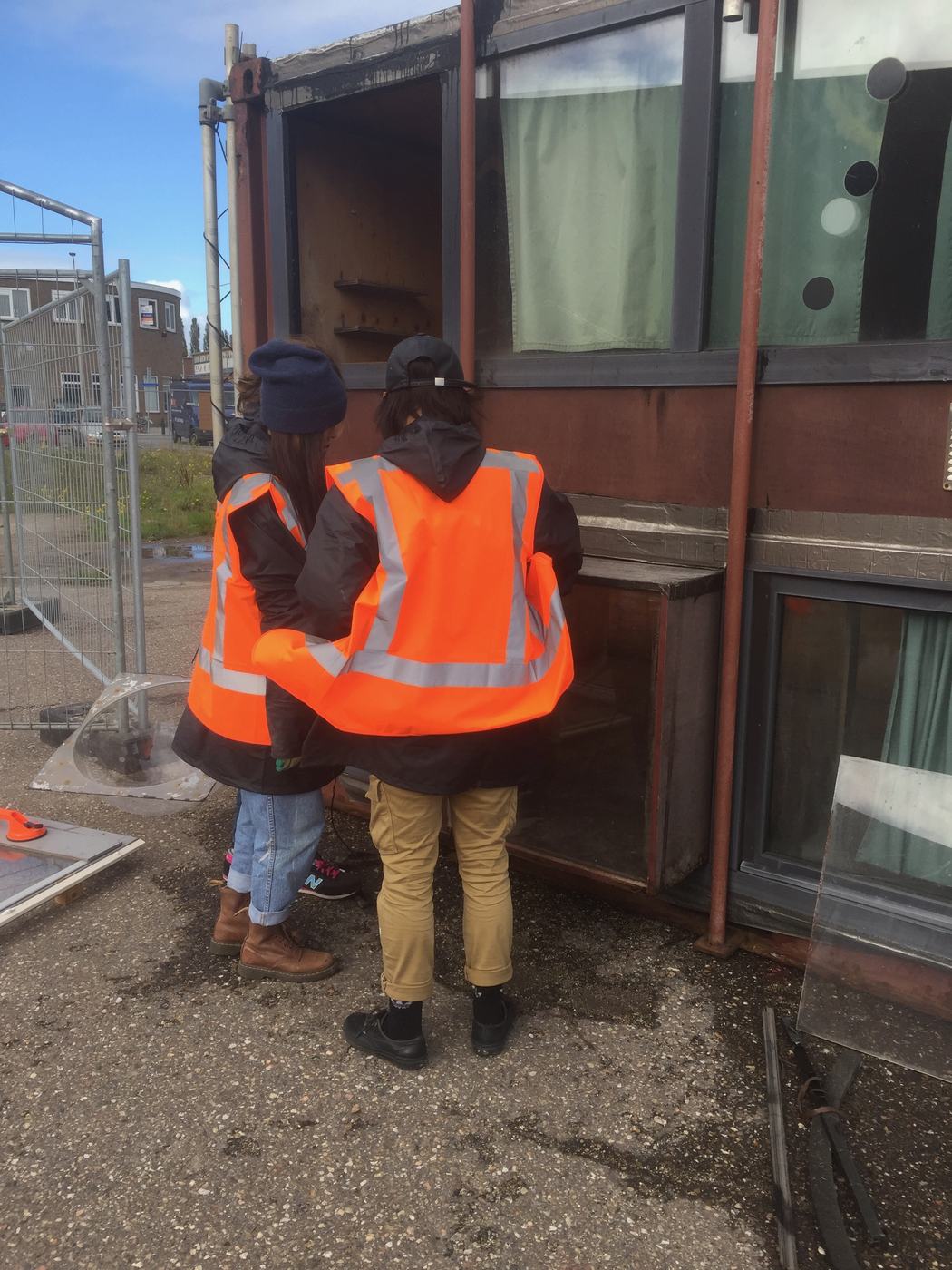 Two people in high visibility jackets at a unit